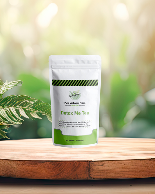 Detox Me Tea bag on wooden table with plants – herbal cleansing tea blend for natural detox and wellness support